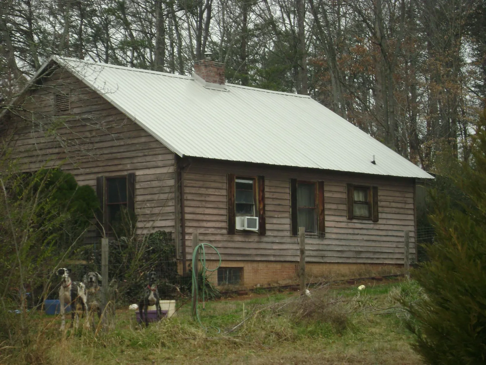 White metal roof on an old wood sided farmhouse, from a Asphalt Shingle Roof Repair job in West Warwick